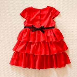 Special editions size 4T red ruffle dress. Buttons in back with black ribbon tie